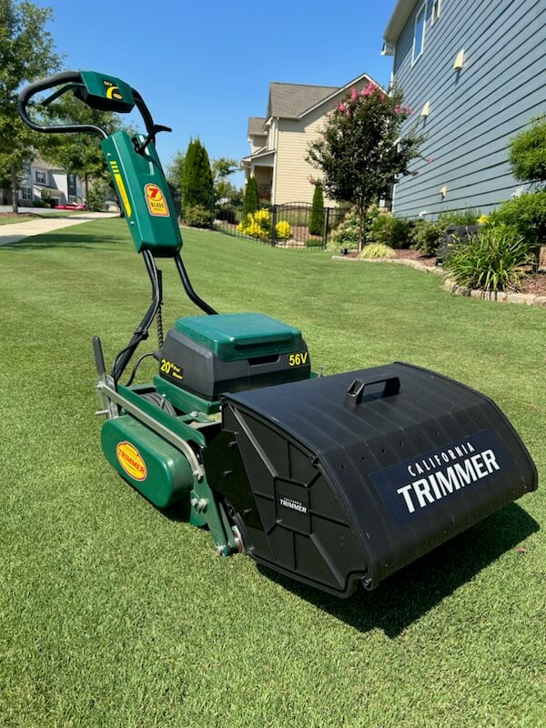 mower with covered bucket attachment in a residential yard